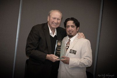 2007 Inductee Butch Rounsaville presenting to 2018 Inductee Carlie Roman