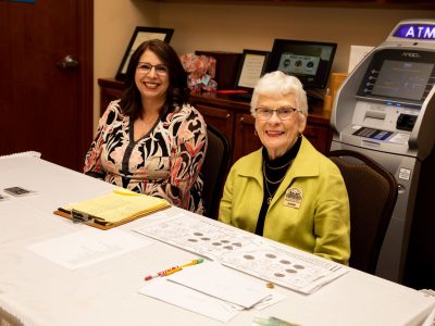 ASL Volunteer Florene Bras and Ticket Chair Joanne Bilbo at registration table.