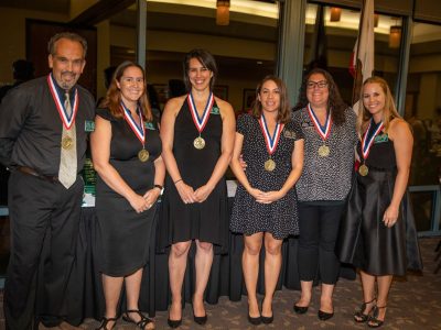 1999 AHS Girls Cross-Country Team accepting Hall of Fame medallions.