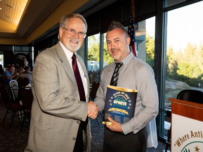 Program Coordinator Tom Lamothe congratulating Gala program designer Conrad Borba on another fabulious Gala Program design.