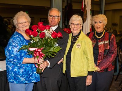 On behalf of the Antioch Sports Legends, Gary Bras presents roses of apprecation to volunteers Sherill Hecock, Joanne Bilbo and Barbara Harris.